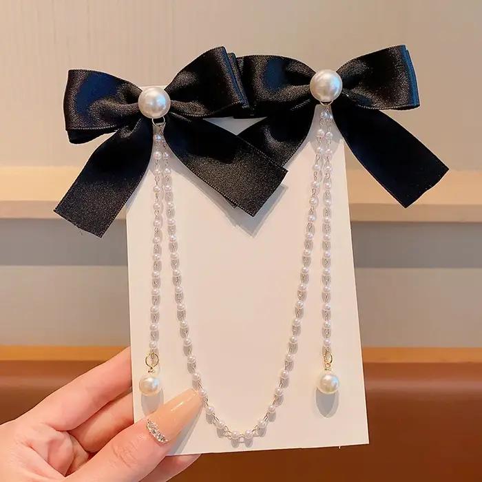 Pince à cheveux avec nœud en chaîne de perles roses